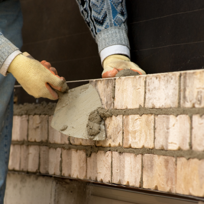 Commercial masonry contractors executing a flawless brick facade on a Texas municipal building.