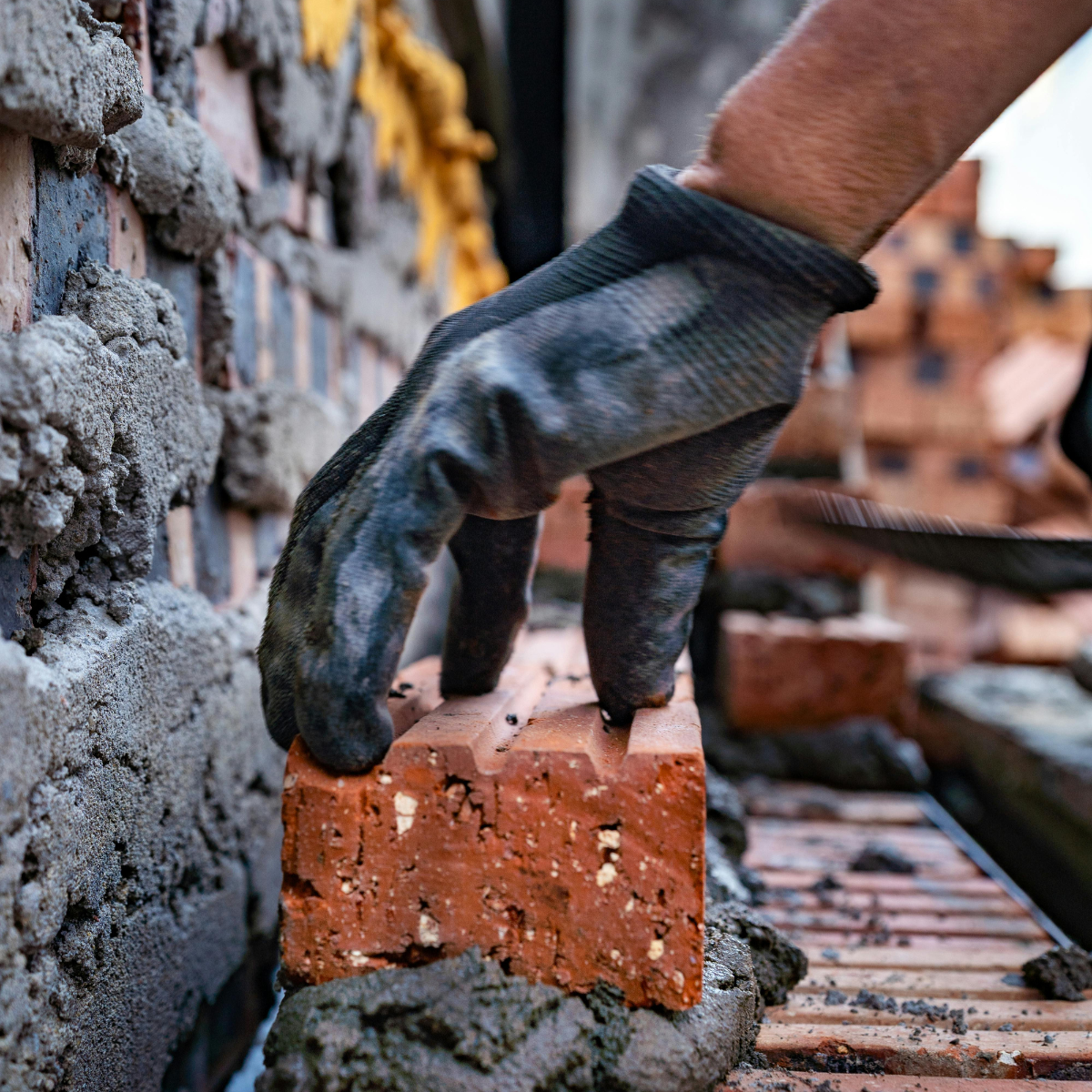 Commercial masonry contractors in Texas laying blocks on a construction site.